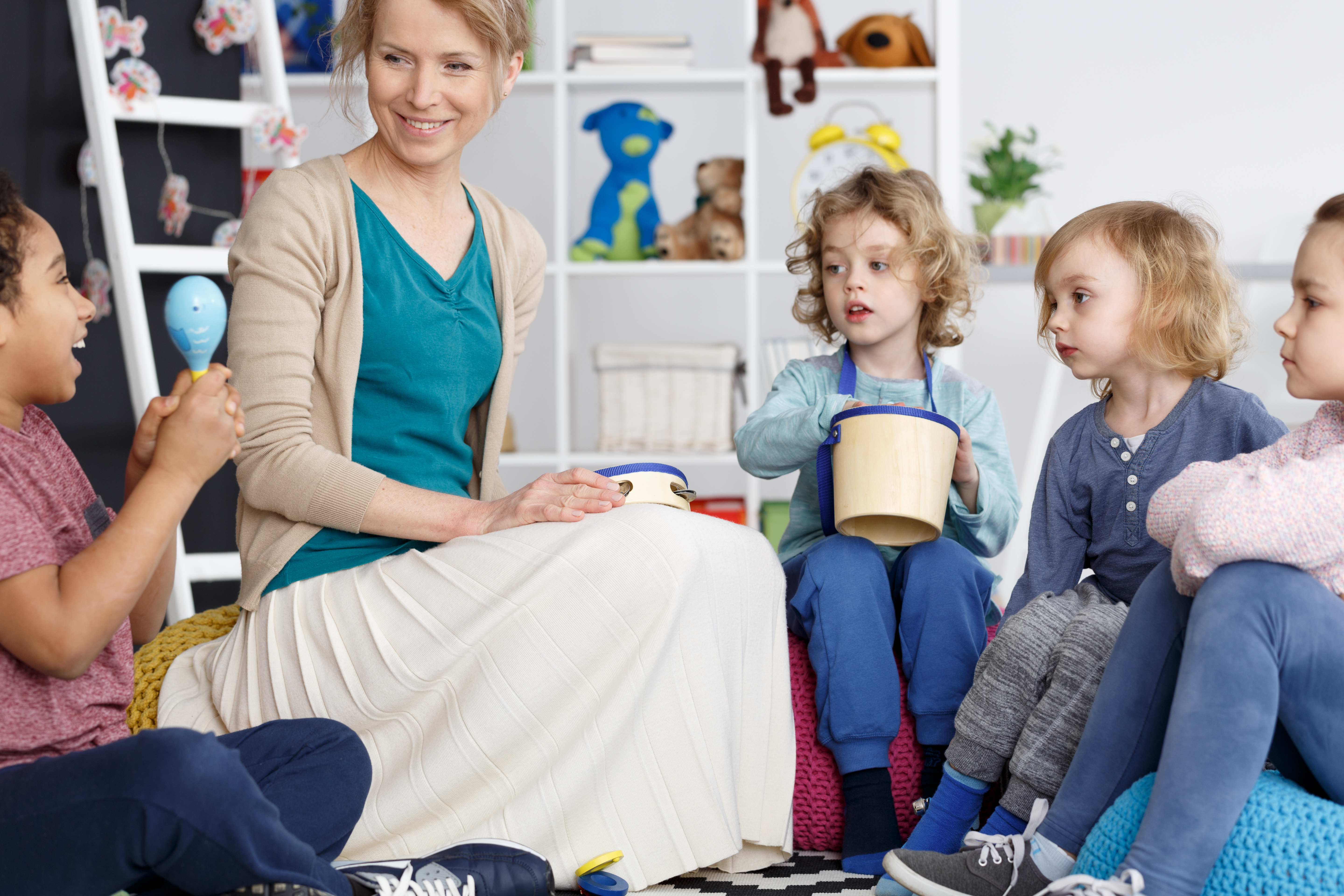 Teacher guiding music and rhythm activity for young learners